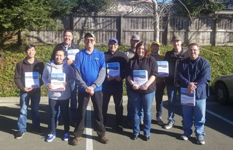 Workplace safety training session with hands-on practice led by expert.