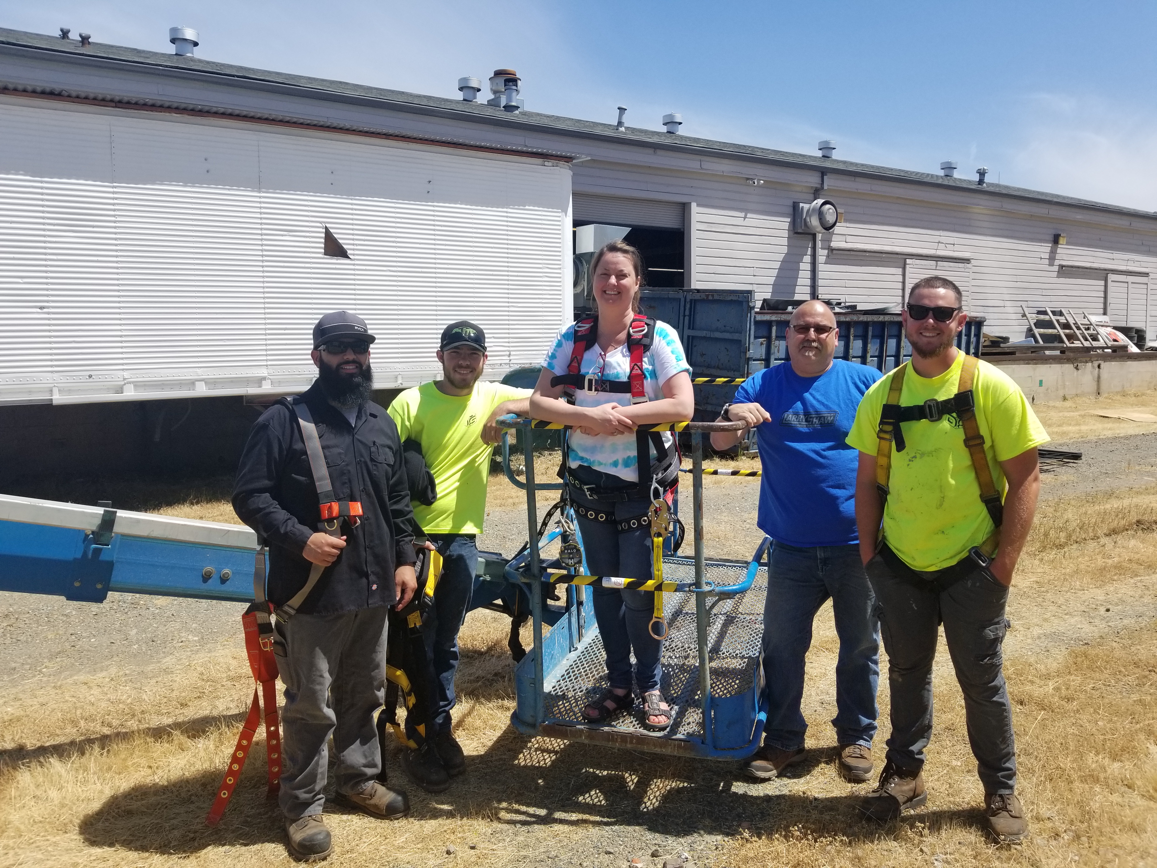 Interactive workplace safety drill with diverse employees in factory setting.