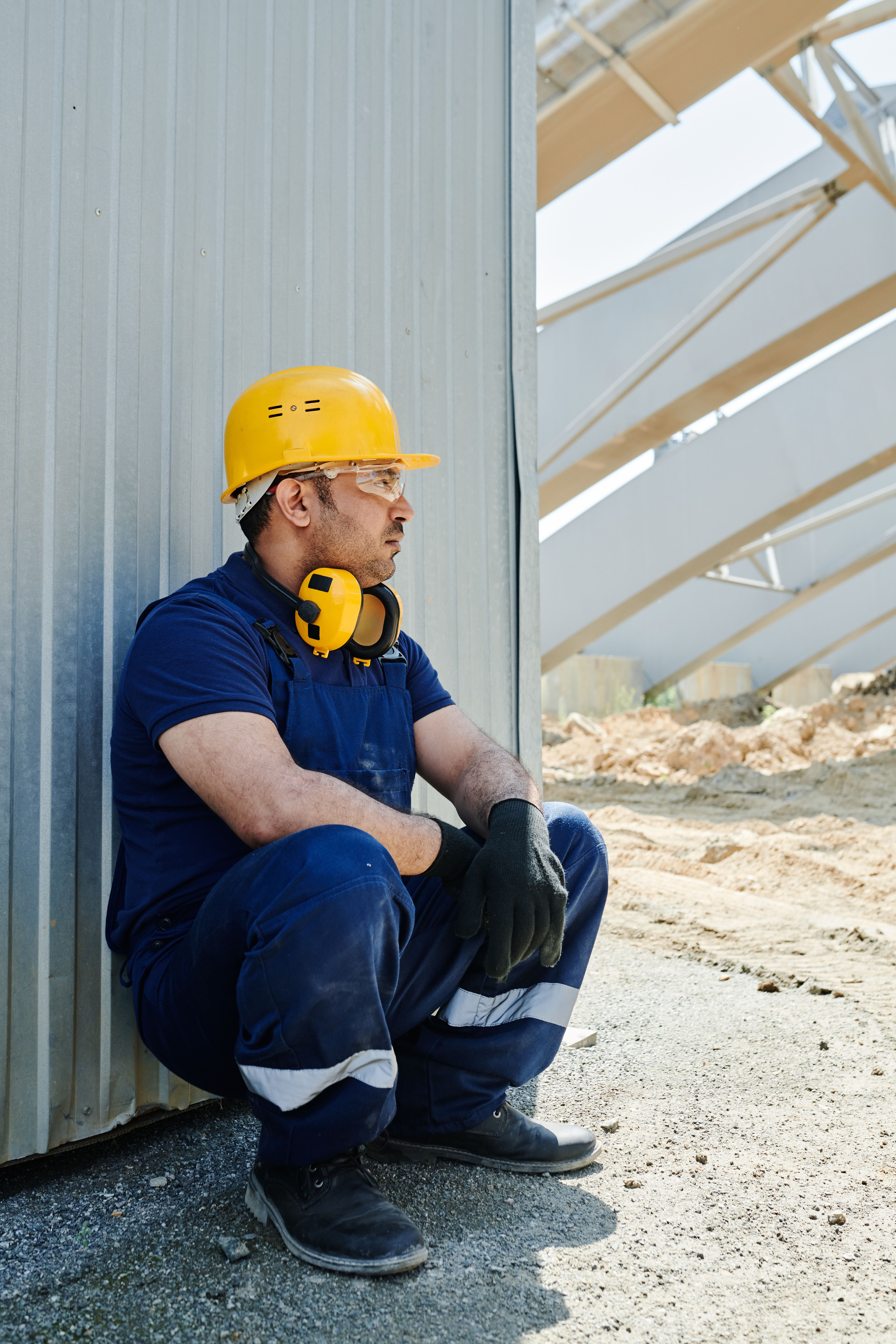 Person recovering from heat exhaustion, applying a cool compress and drinking water indoors for effective heat illness prevention